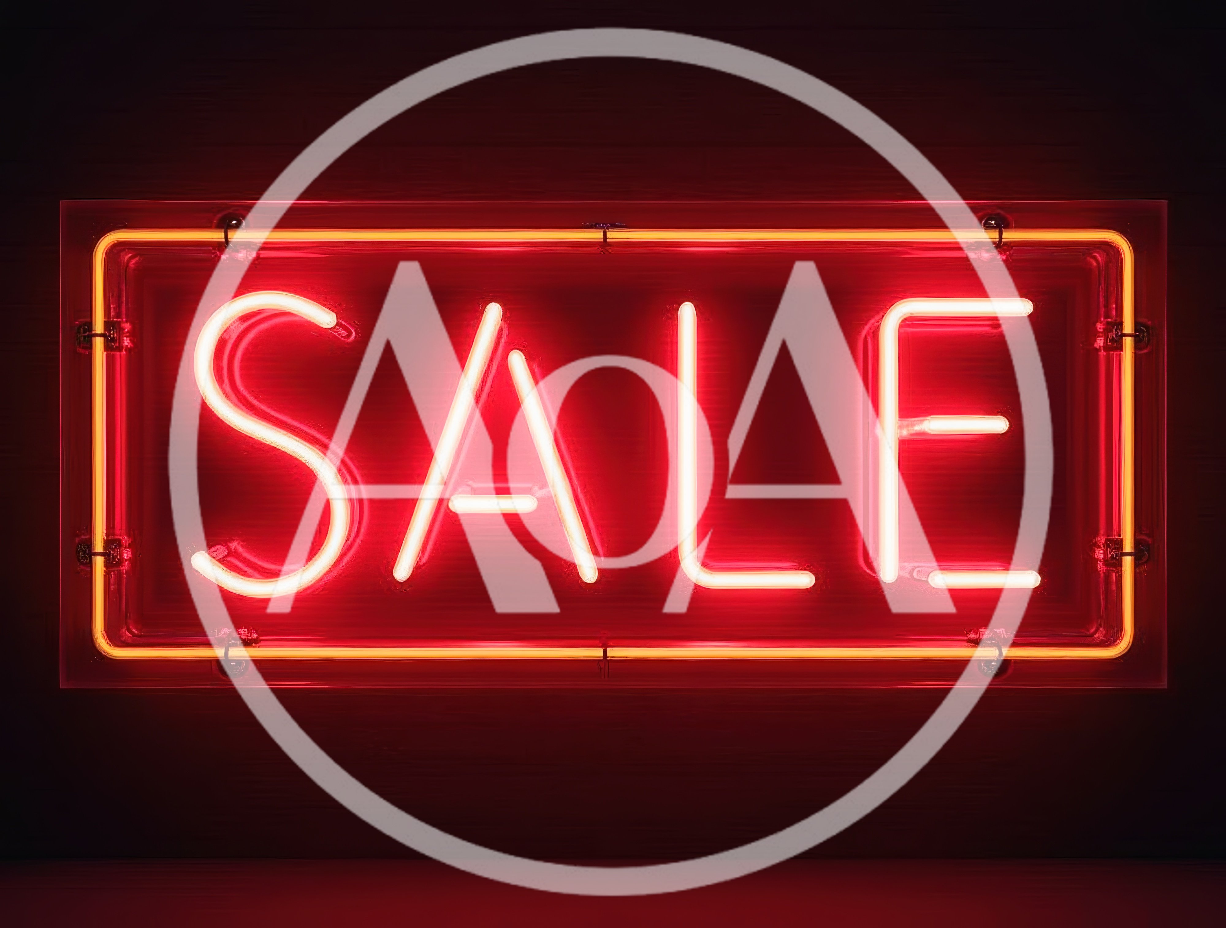 Bright Red Neon Sale Sign On Dark Wall