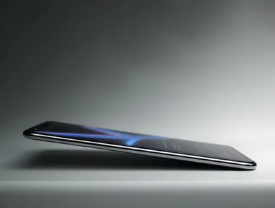 Sleek Modern Smartphone Resting On A Reflective Surface