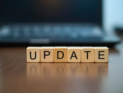 Wooden Blocks Spelling Update On A Desk