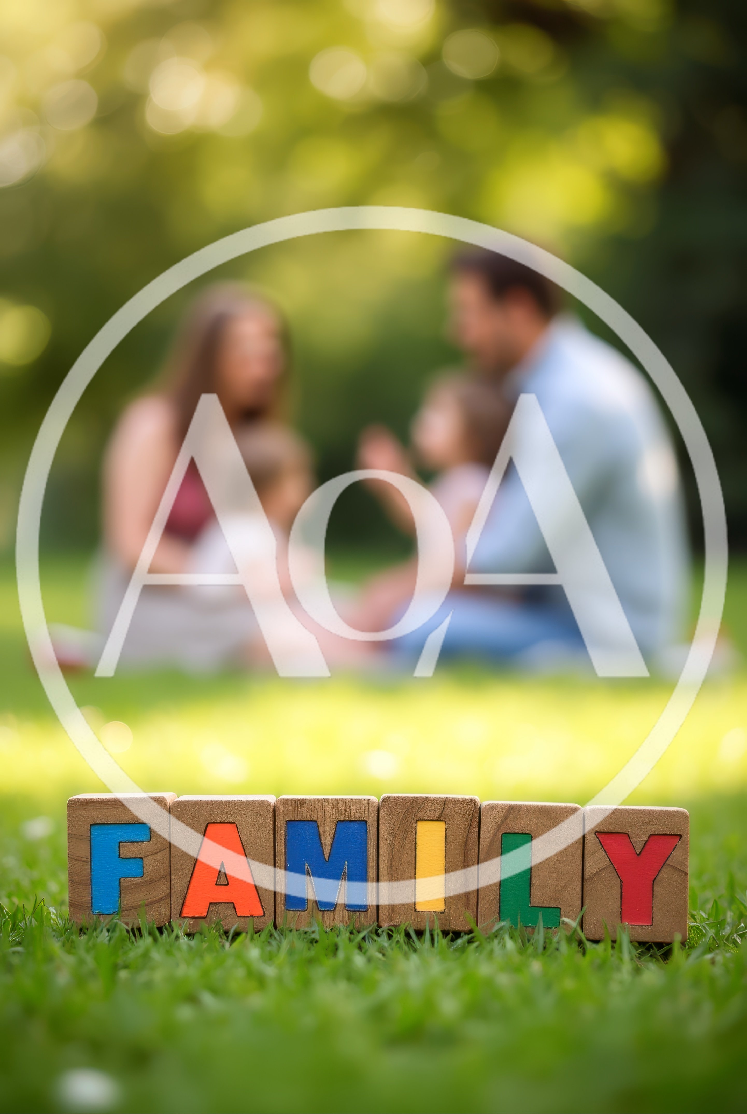 Wooden Blocks Spelling Family With Blurred Family In Background