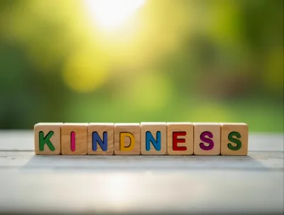 Wooden Blocks Spelling Kindness on a Sunny Outdoor Table