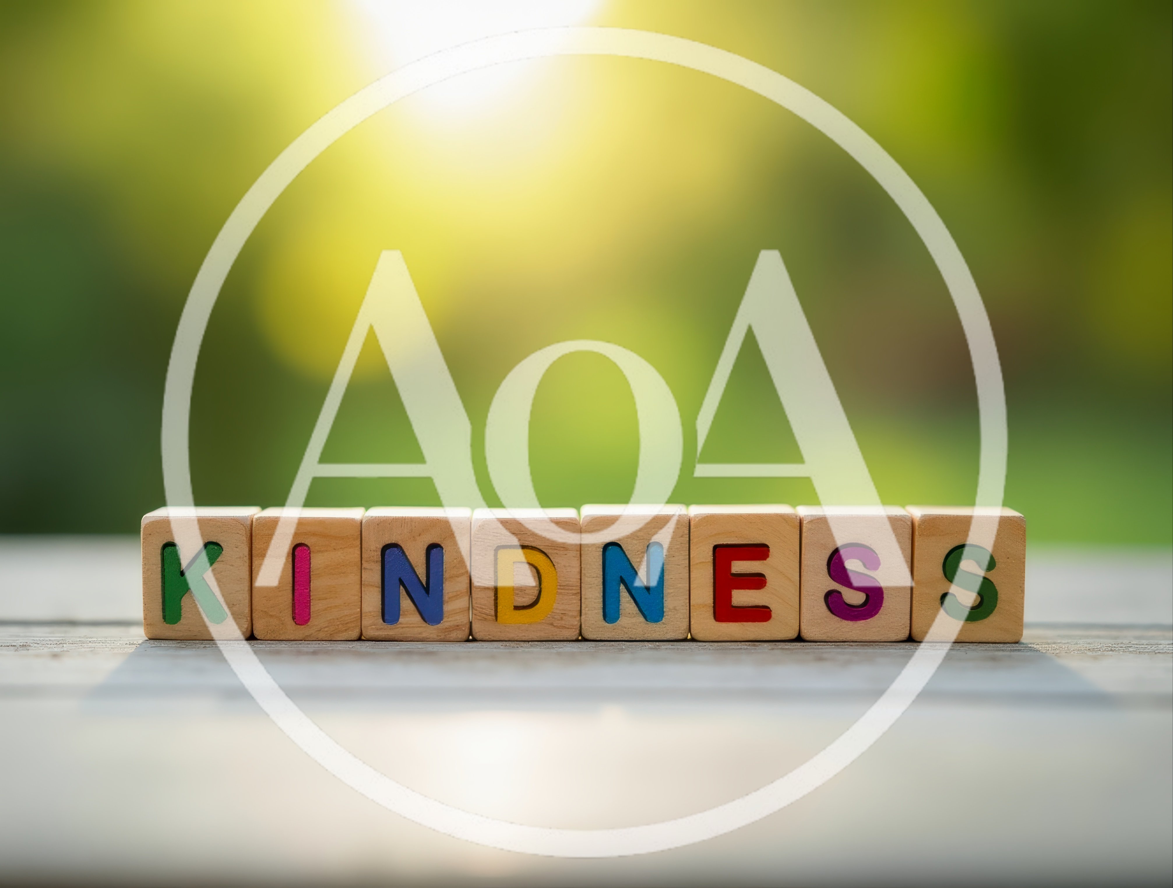 Wooden Blocks Spelling Kindness on a Sunny Outdoor Table