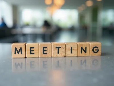 Wooden Blocks Spelling Meeting On A Reflective Surface