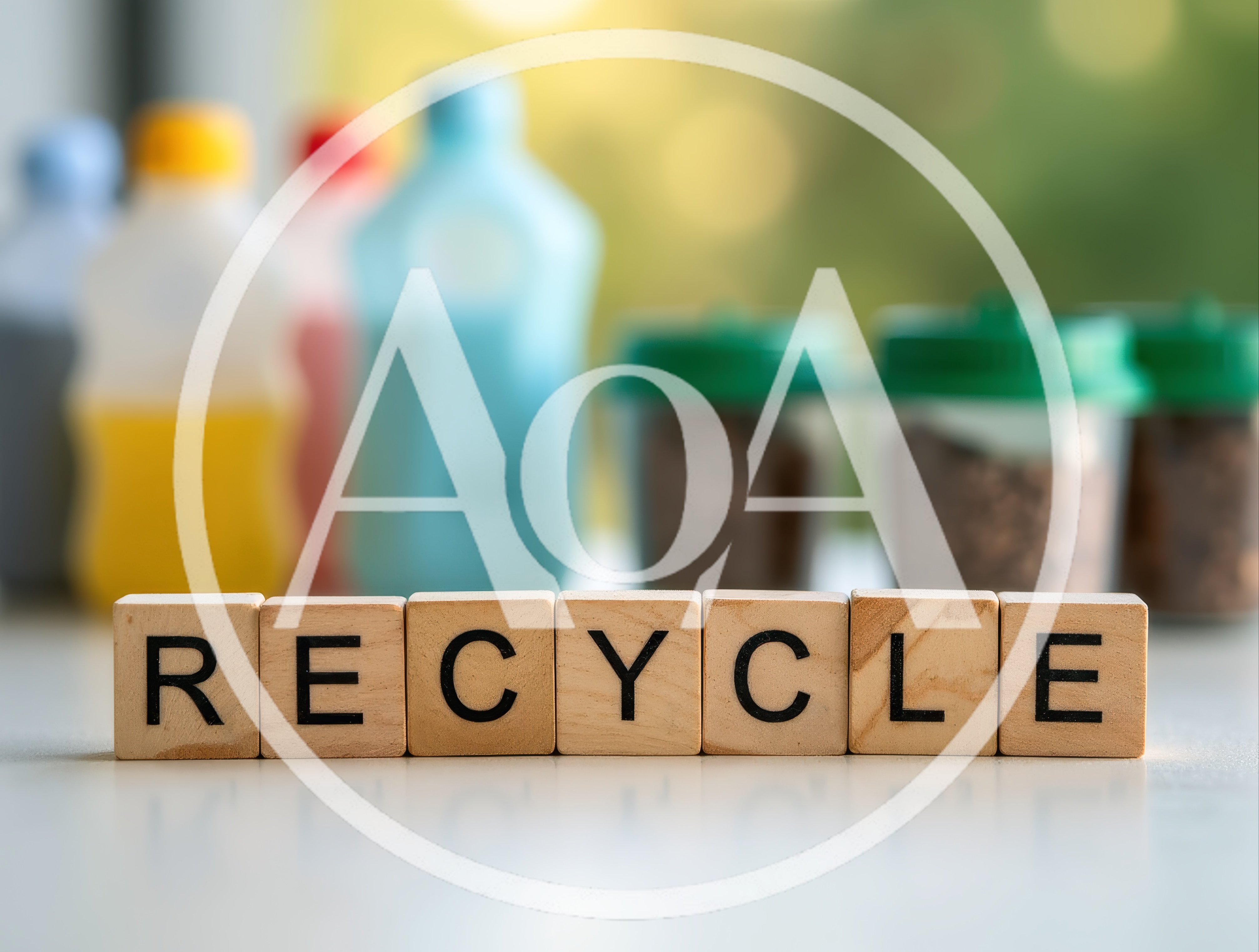 Wooden Blocks Spelling Recycle With Blurred Recyclable Containers