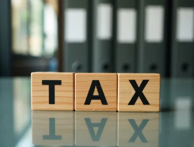 Wooden Blocks Spelling Tax on Office Desk