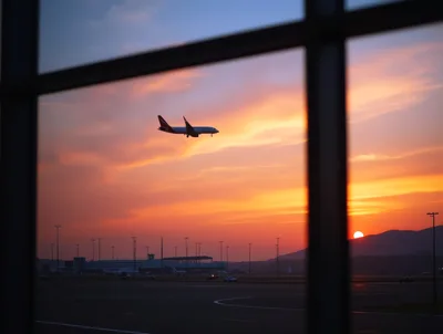 Commercial Airplane Landing at Sunset Over Airport Tarmac