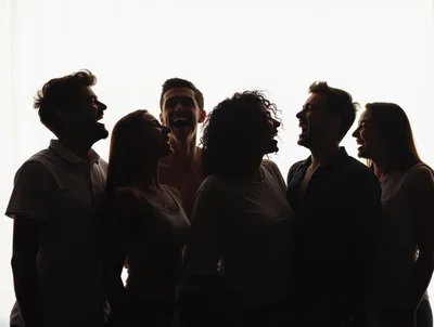 Group of Friends Laughing Together in Silhouette