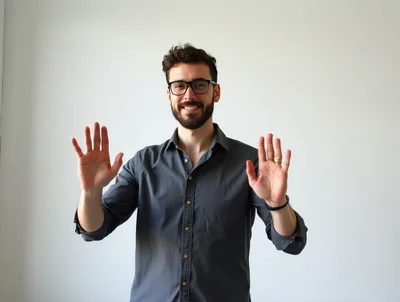 Smiling Man Gesturing With Open Hands Against White Background