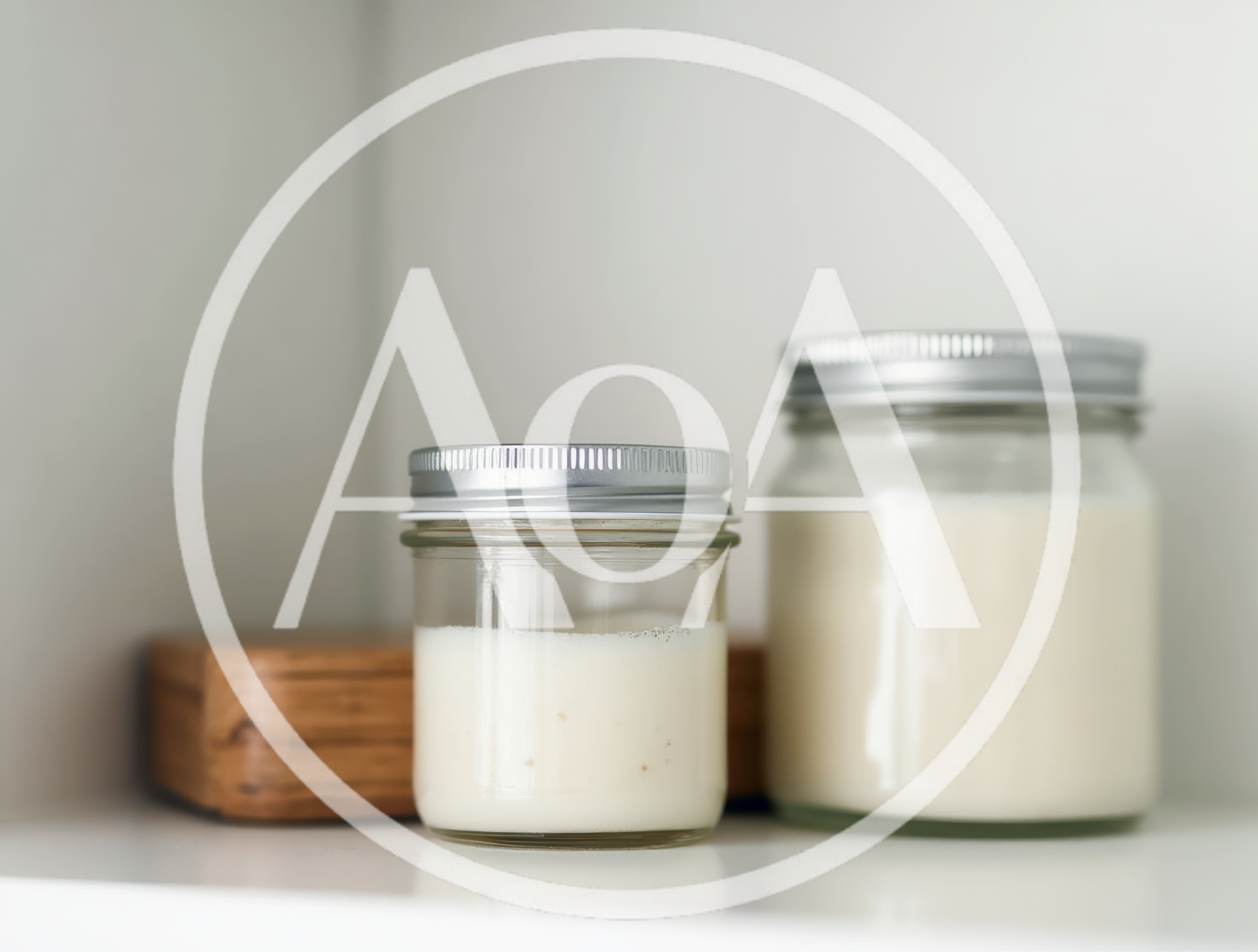 Two Glass Jars With White Cream On A Shelf