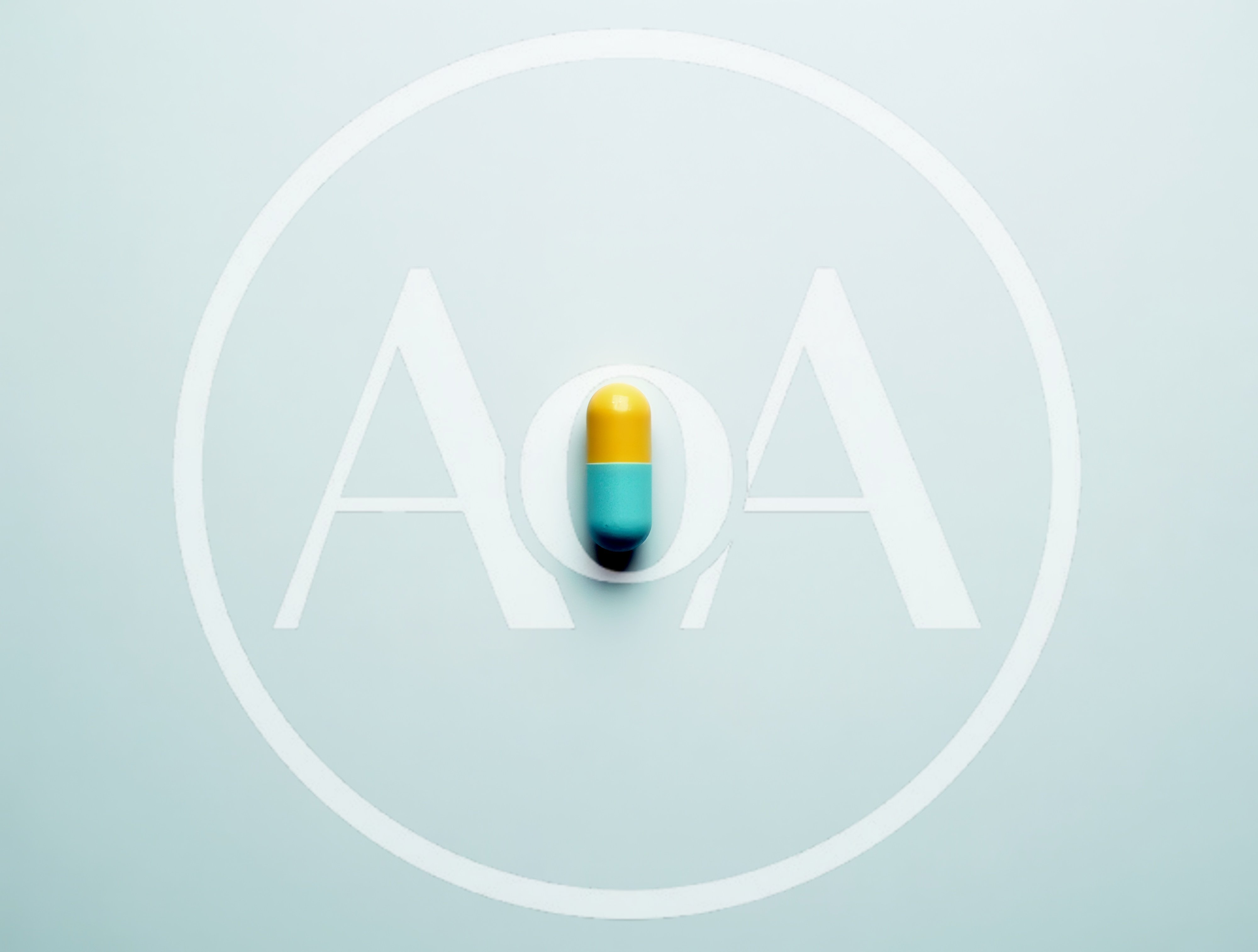 Single Yellow And Blue Capsule Pill On White Background