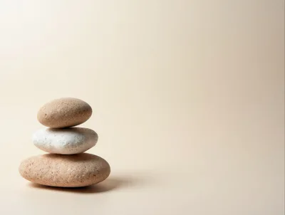 Stacked Smooth Stones On A Beige Background