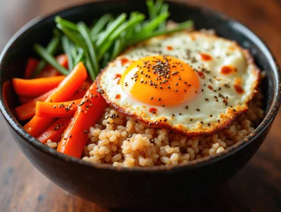 Bowl Of Brown Rice With Fried Egg And Vegetables