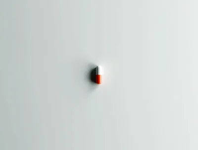 Single Red And White Medical Capsule On White Background
