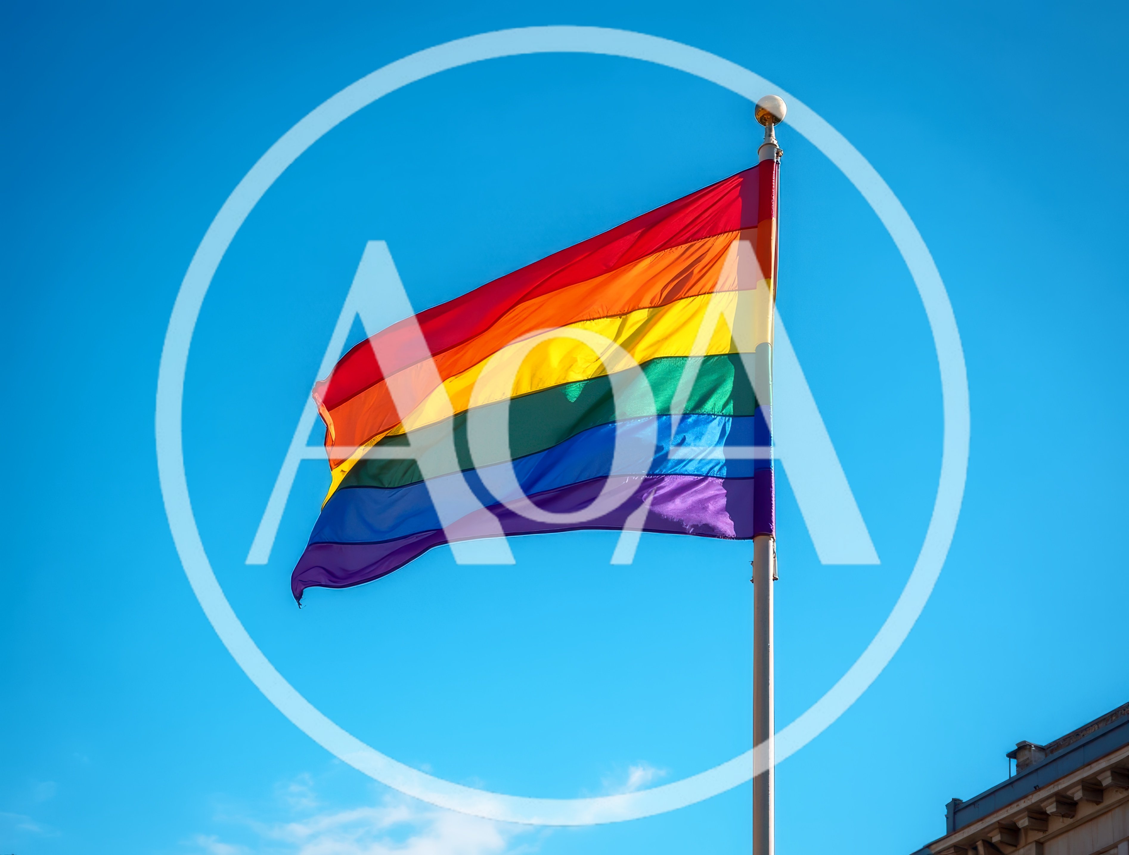 Rainbow Pride Flag Waving Against Clear Blue Sky