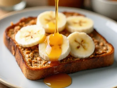 Honey Being Poured Over Banana Peanut Butter Toast