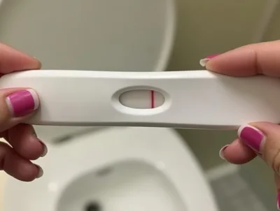 Woman Holding A Single Line Pregnancy Test