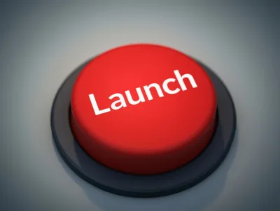Red Launch Button On A Grey Surface