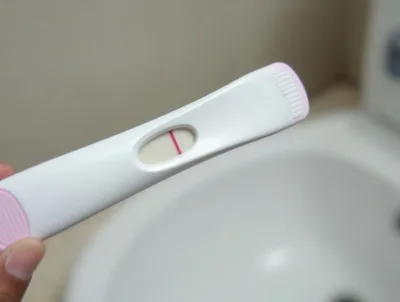 Hand Holding A Single Line Pregnancy Test