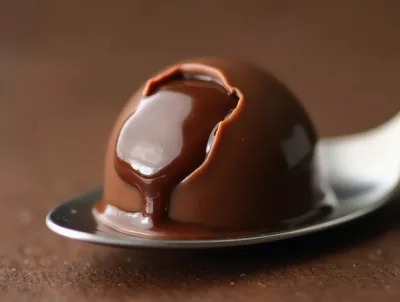 Chocolate Truffle With Liquid Filling On A Spoon