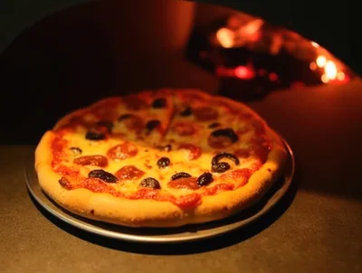 Pepperoni Pizza Baking Inside A Wood Fired Oven
