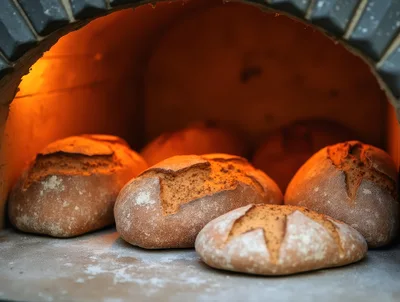Artisan Bread Loaves Baking Inside A Wood Fired Oven
