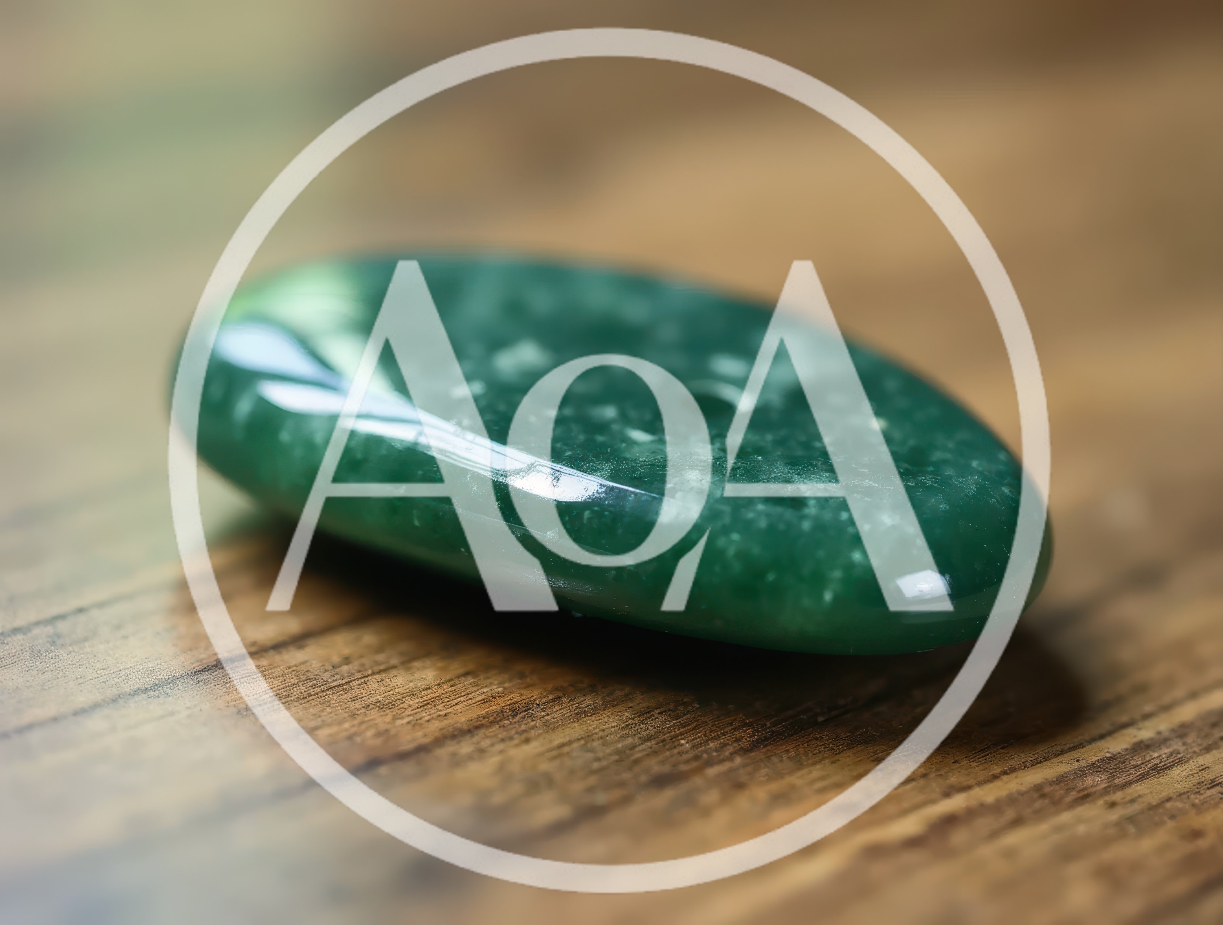 Polished Green Aventurine Gemstone On Wooden Surface