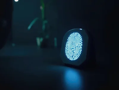 Glowing Digital Fingerprint Scanner On Dark Desk
