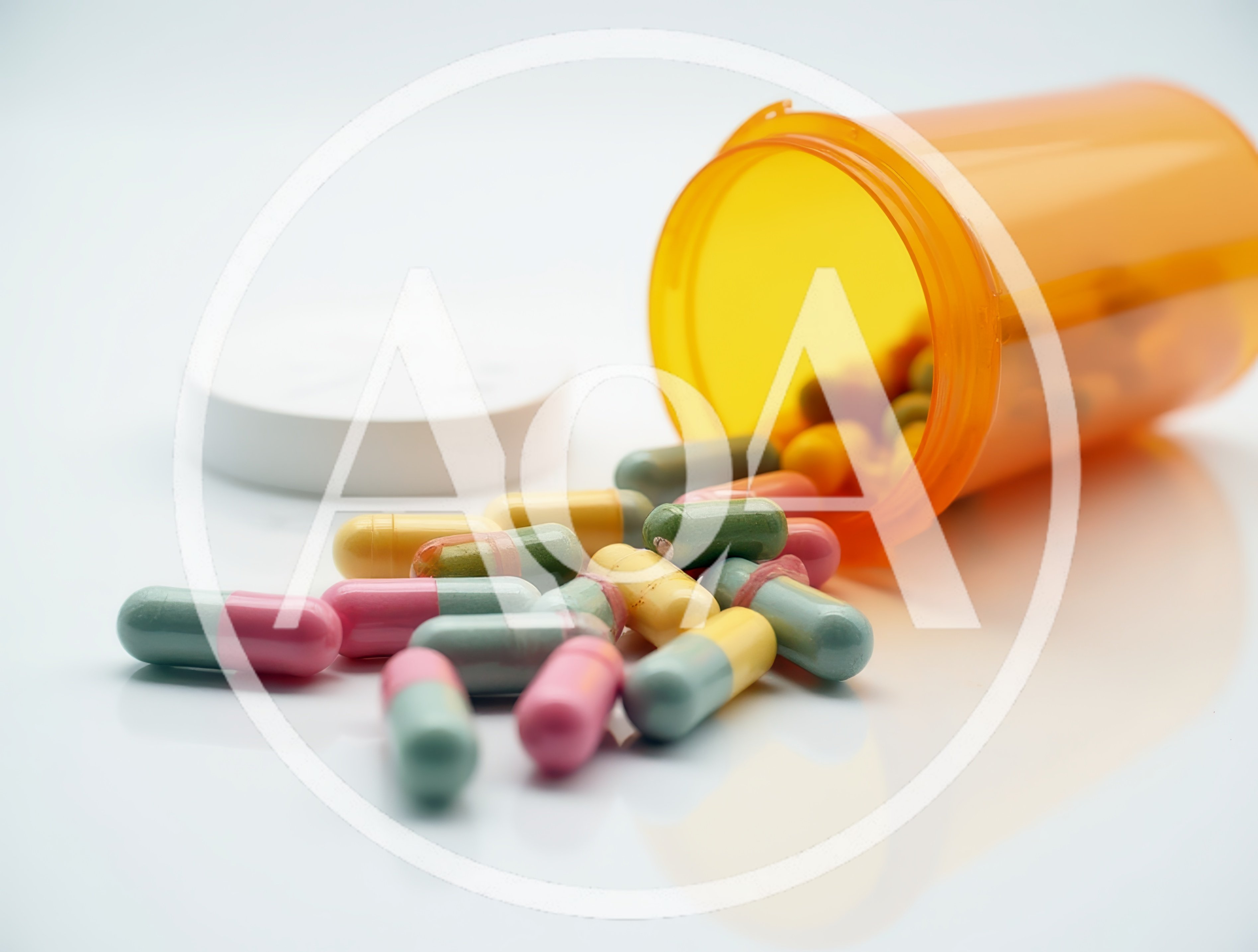 Prescription Medication Capsules Spilled From An Orange Bottle