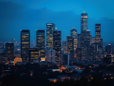 Modern City Skyline At Night With Illuminated Skyscrapers