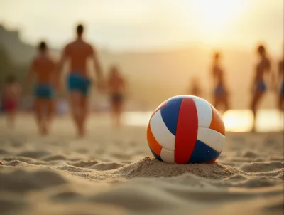 Volleyball Resting On Sandy Beach At Sunset