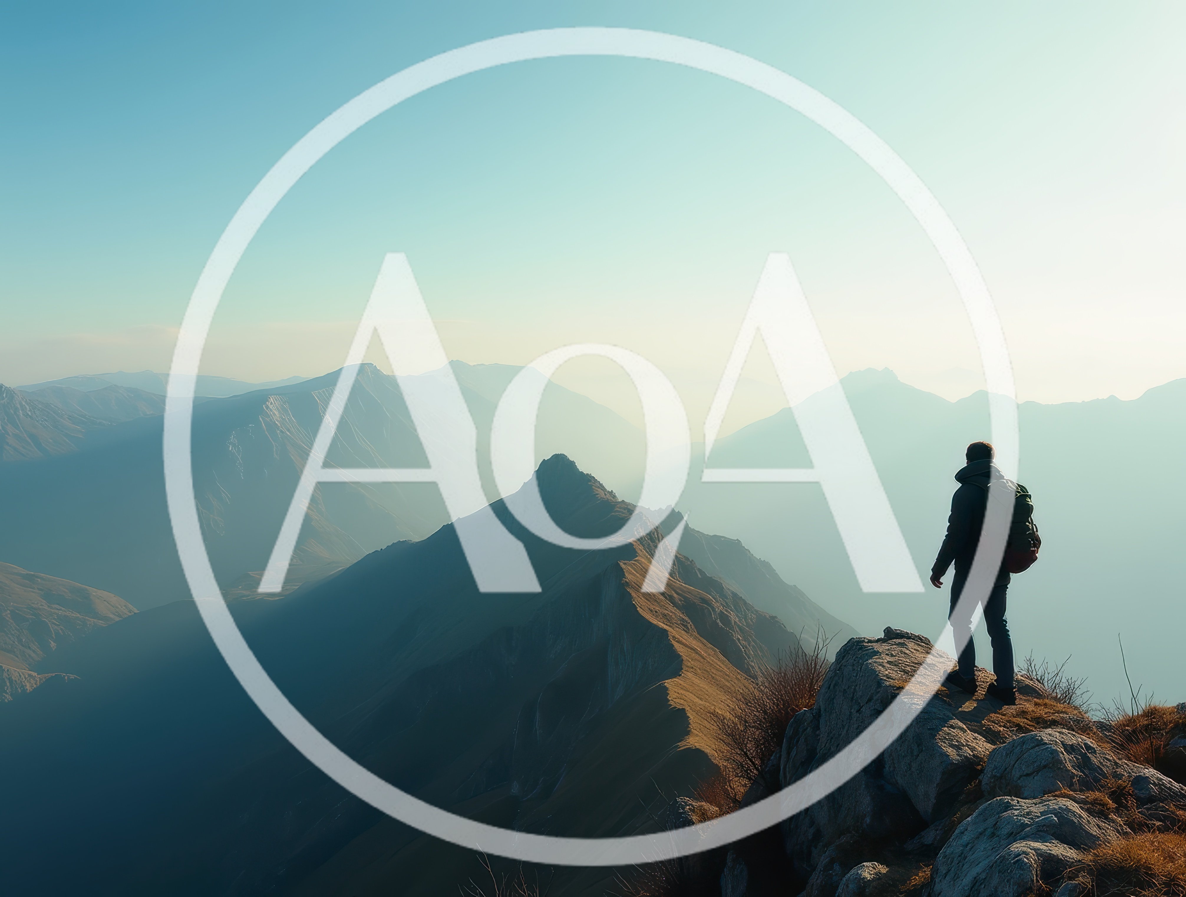 Hiker Standing On A Mountain Peak Overlooking A Valley