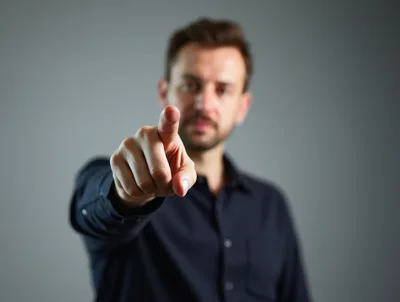 Man Pointing Directly At Camera With Focused Expression