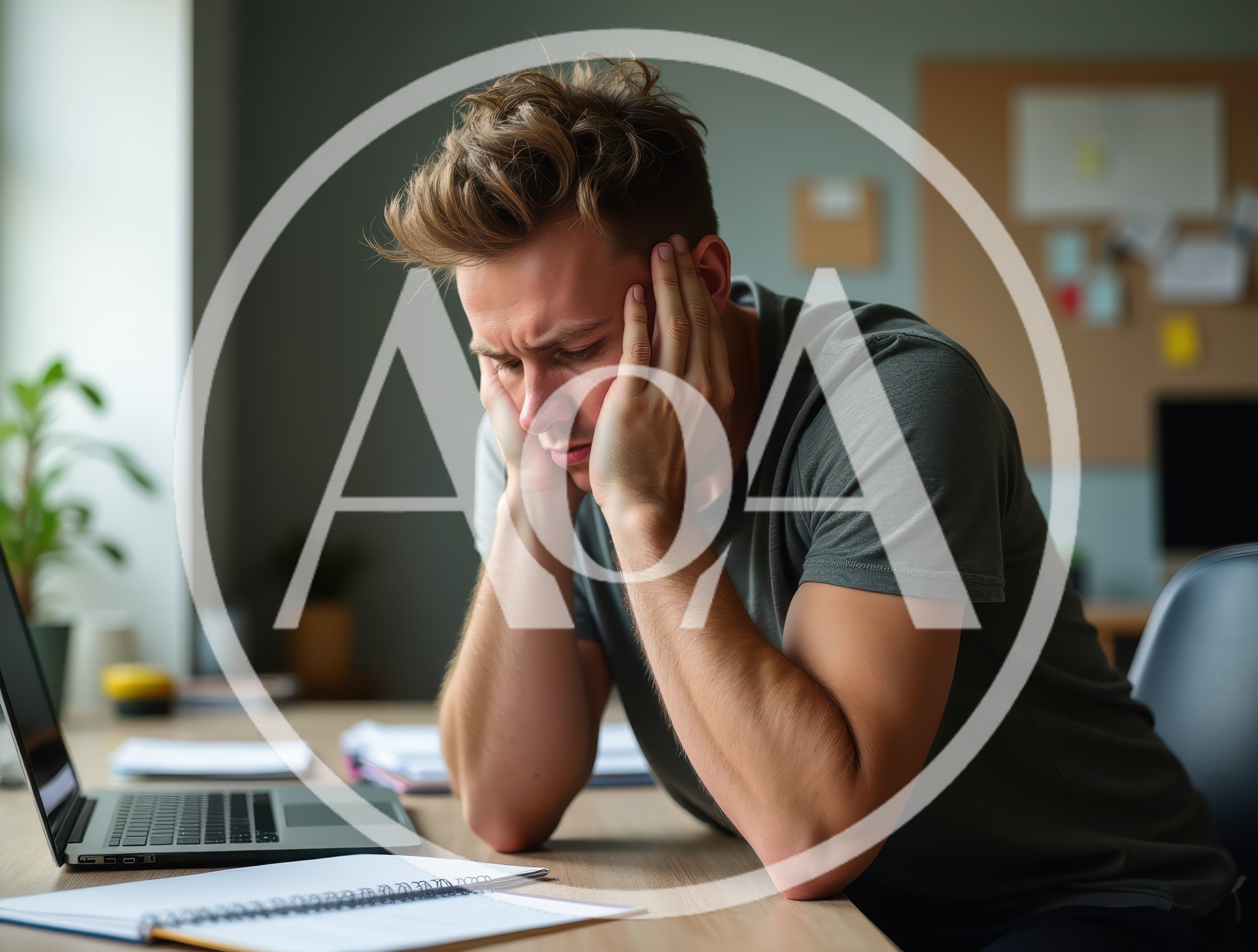 Stressed Young Man Working At Desk
