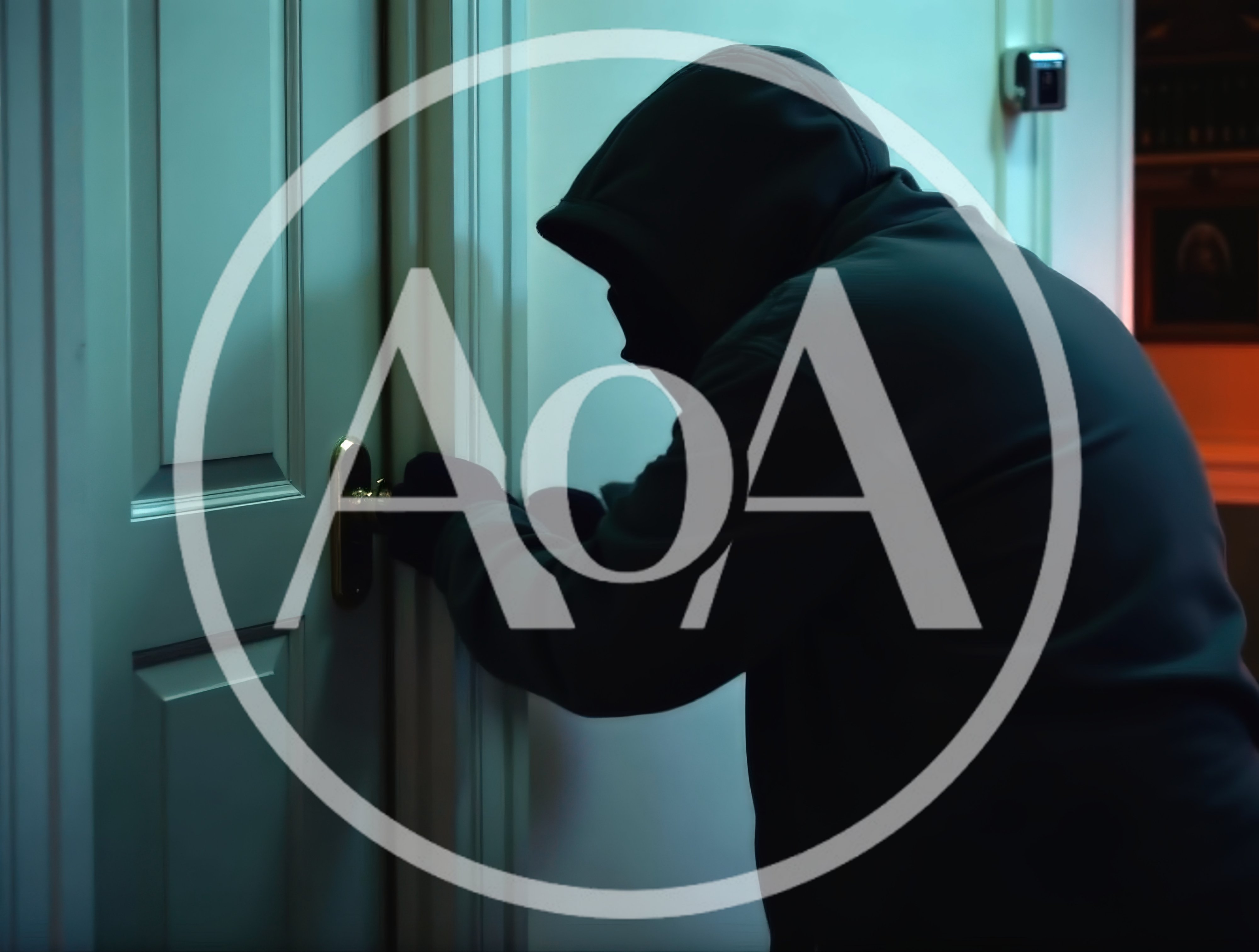 Burglar Wearing Hoodie Trying To Pick A Door Lock