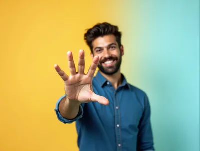 Smiling Man Showing Five Fingers Against Colorful Background