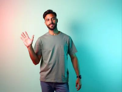 Young Man Waving Hello Against Colorful Gradient Background