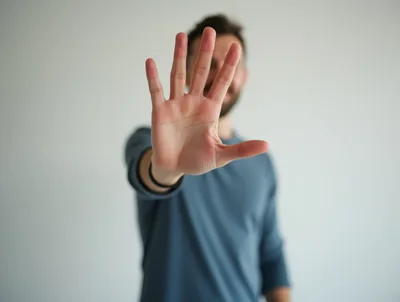 Man Holding Hand Up In Stop Gesture