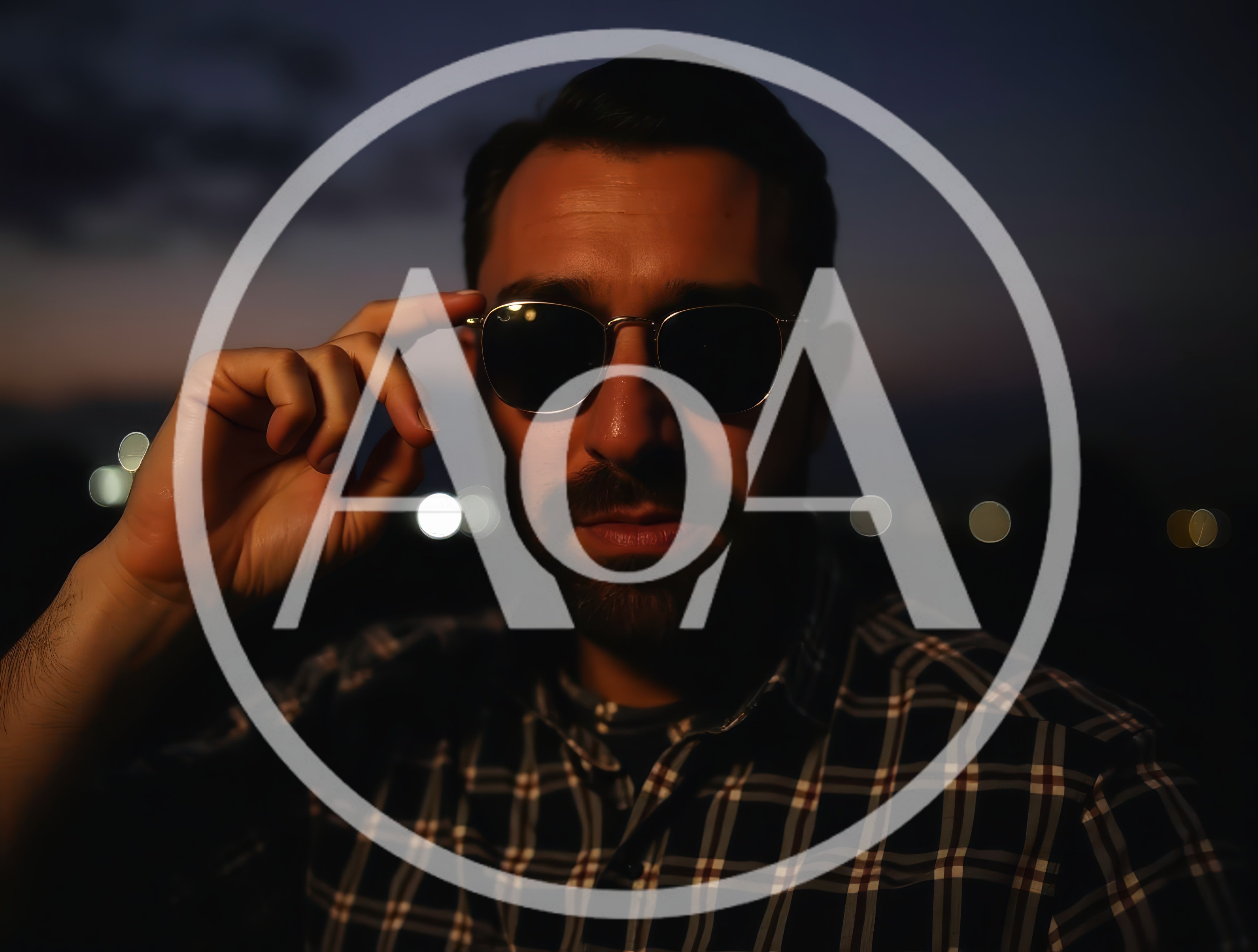 Man Adjusting Sunglasses During Twilight Outdoors