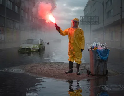 Person in Hazmat Suit Holding Flare in Flooded City