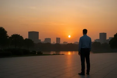 Businessman Standing Alone Looking At City Skyline Sunset