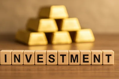 Gold Bars Behind Wooden Blocks Spelling Investment
