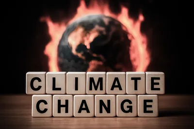 Climate Change Text On Wooden Blocks With Burning Earth