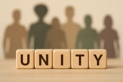 Wooden Blocks Spelling Unity With Blurred Human Silhouettes
