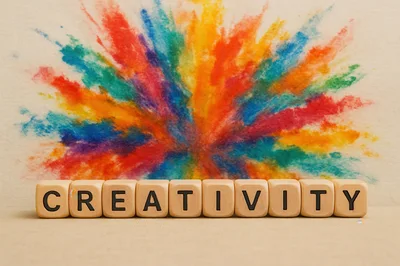 Wooden Blocks Spelling Creativity Against Colorful Watercolor Background