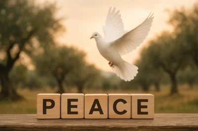 White Dove Flying Above Wooden Blocks Spelling Peace