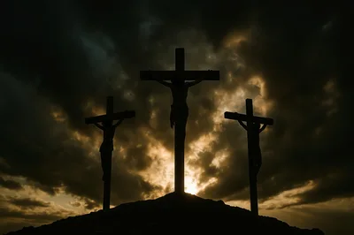 Silhouetted Crucifixion Scene Against Dramatic Stormy Sunset Sky