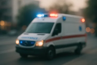 Blurred Ambulance Driving On City Street