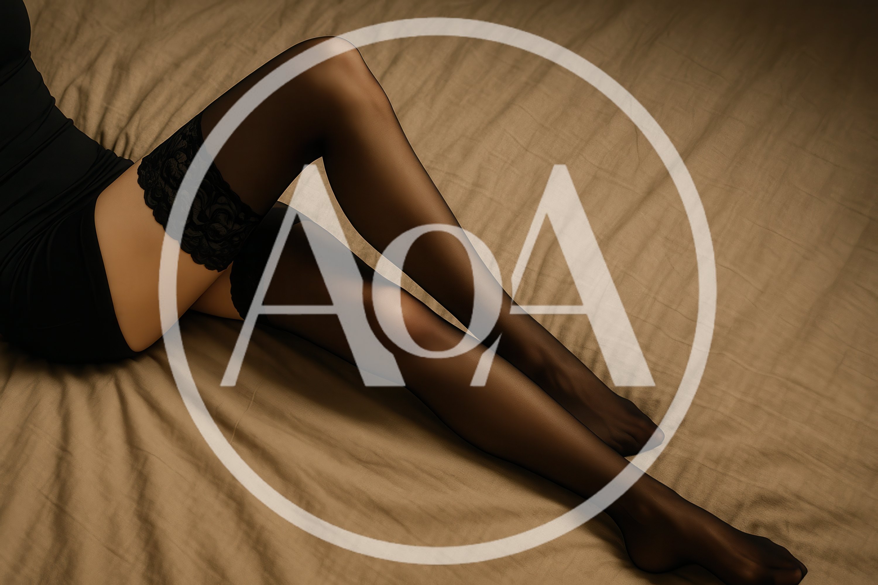 Woman Wearing Black Stockings On A Bed