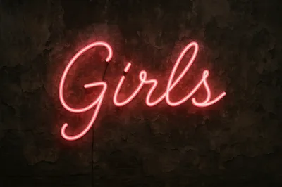 Neon Girls Sign on Dark Textured Wall