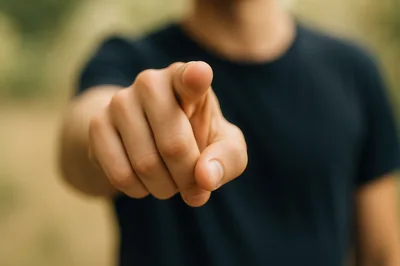 Person Pointing Directly At Camera In Outdoor Setting